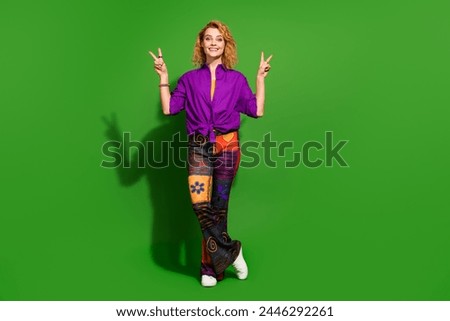 Photo portrait of lovely young lady show double v-sign dressed stylish violet clothes isolated on green color background