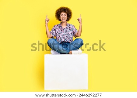 Full length photo of cheerful excited lady dressed shirt pointing two fingers up empty space isolated yellow color background