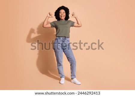 Full length photo of perky confident woman wear khaki t-shirt jeans trousers indicating at herself isolated on beige color background
