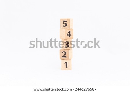 Wooden blocks stacked with numbers isolated on white background.