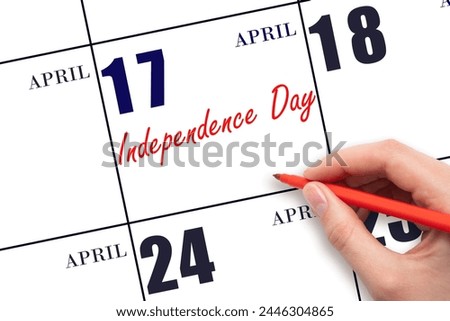 April 17. Hand writing text Independence Day on calendar date. Save the date. Holiday. Important date.