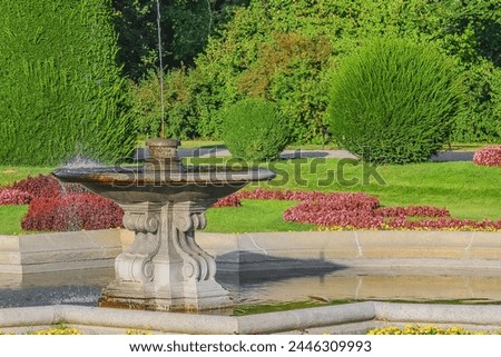 It's view of fountain and flowersbed in a park. It is photo park in sunny
day