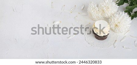 Cupcake with a bouquet of white peony flowers. Holiday greetings concept, banner, background. Festive still life with selective focus and copy space for text