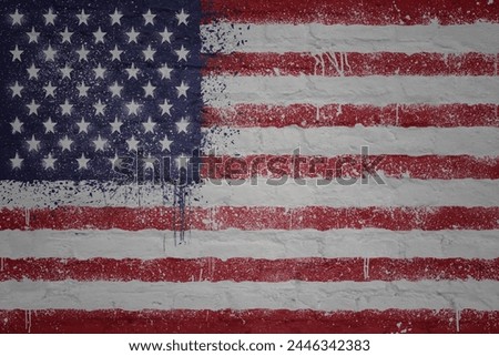 colorful painted big national flag of united states of america on a massive old brick wall