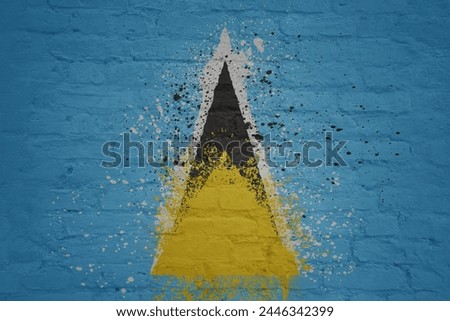 colorful painted big national flag of saint lucia on a massive old brick wall