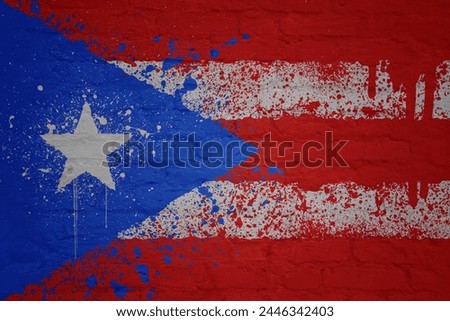 colorful painted big national flag of puerto rico on a massive old brick wall