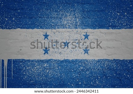 colorful painted big national flag of honduras on a massive old brick wall