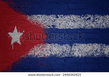 colorful painted big national flag of cuba on a massive old brick wall