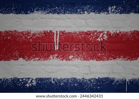 colorful painted big national flag of costa rica on a massive old brick wall