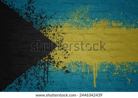 colorful painted big national flag of bahamas on a massive old brick wall