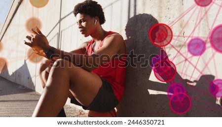 Image of media icons over african american man sitting. Global business and digital interface concept digitally generated image.