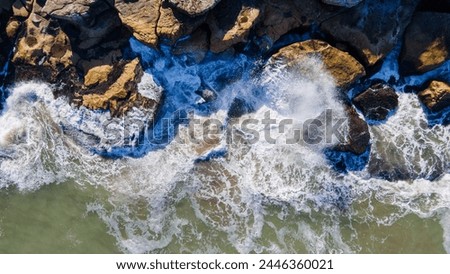 Aerial photography of ocean hitting rocks in Mar del Plata