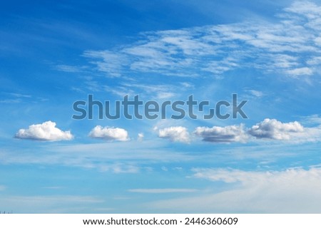white clouds lined up in one row blue sky photo of nature