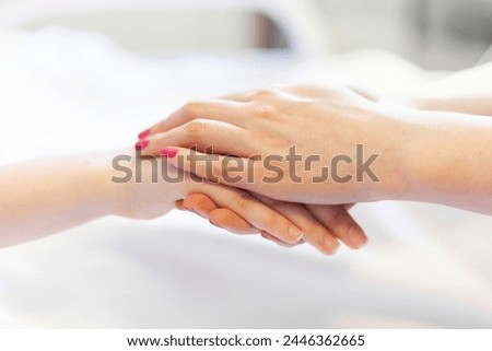 Nurse,doctor or friend holding the hand of an woman. patient to consoling and support after finished surgery about illness in private room at hospital ward for health insurance ands support concept Royalty-Free Stock Photo #2446362665