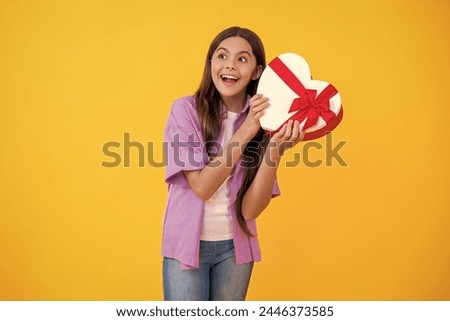 teen girl hold gift on Valentines Day. teen girl holding box of chocolates. be my valentine. teen girl hold heart box for Valentines Day. teen girl has Valentines mood. spirit of love on Love Day