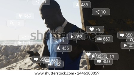 Image of icons over exercising african american man using smartphone. Global connections, wellbeing, fitness and healthy lifestyle concept digitally generated image.
