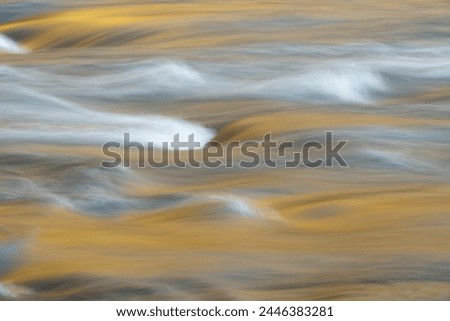 Abstract image with a slow shutter speed of light reflecting off the rapids and waves of the New River.