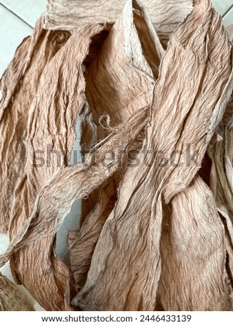 Bark is the basic material for making noken or traditional bags of the Paniai people, Papua Indonesia Royalty-Free Stock Photo #2446433139