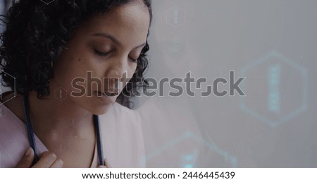 Image of network of medical icons and data processing over biracial female doctor. Global science, medicine, research, computing and data processing concept digitally generated image.