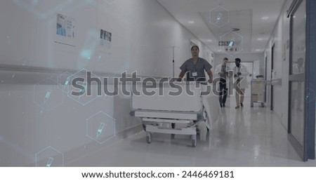 Image of network of medical icons and data processing over diverse doctors in hospital. Global science, medicine, research, computing and data processing concept digitally generated image.