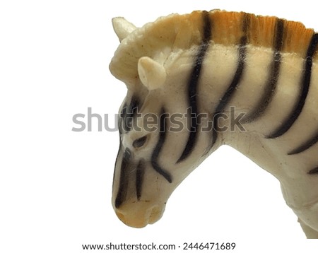 The muzzle of a toy zebra on a white background. Animal zebra. Part of the body of a zebra head on a white background