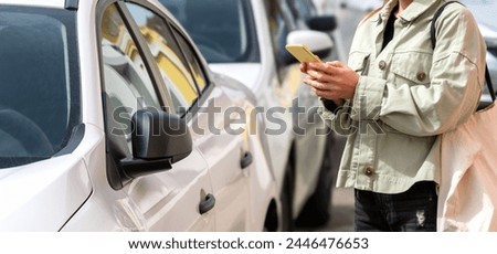 Woman unlocks the car rental vehicle using the mobile app on her smartphone.