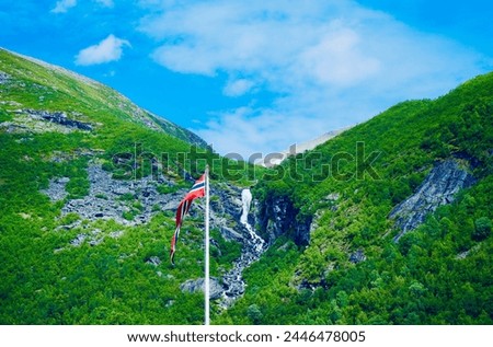 Norwegian flag in Valldal with waterfall background