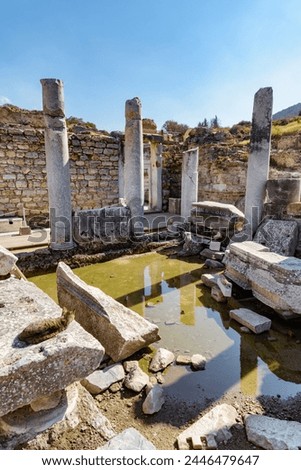 Scenic ruins of the latrines of Ephesus (Efes). Awesome view of public municipal toilets of the ancient Greek city at Izmir Province, Turkey. Ephesus is a popular tourist attraction in Turkey. Royalty-Free Stock Photo #2446479647