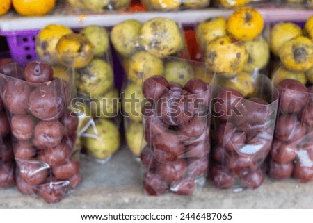 selective focus Plum fresh fruit in a clear plastic bag Selling fruit at the market