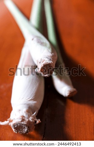 Several stems of Cymbopogon or Lemongrass, on a natural brown wooden background, stock photo, herbal.