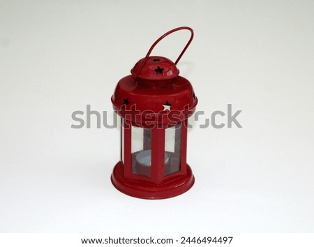 Vintage red arabic lantern for glowing candles on the white background