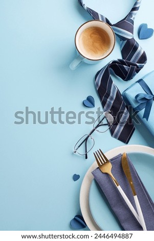 Dad’s day banquet: Top view vertical photo of festive Father's Day table setting with coffee, stylish tie, and thoughtful gifts, on blue surface perfect for holiday captions