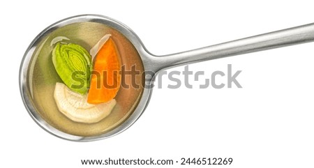 Spoon of vegetable broth isolated on white background, top view