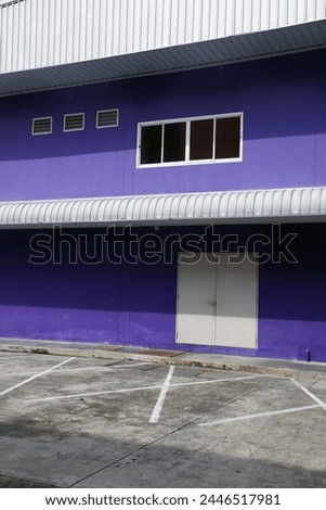 Bangkok, Thailand, Asia - 09 28 2010 : Exterior photo facade front view of a thai stufio film building painted in purple blue color from the outside with the entrance of the studiofor photo film shoot