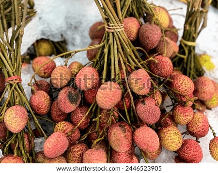 a photography of a bunch of lychle fruits on a table.