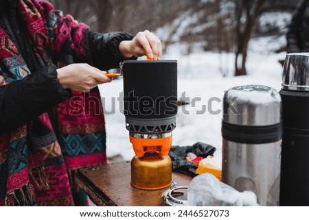 Hiking Camping Kitchen, Cooking on a Burner, Hiking in the Forest with a Gas Burner, Camping in Nature. High quality photo