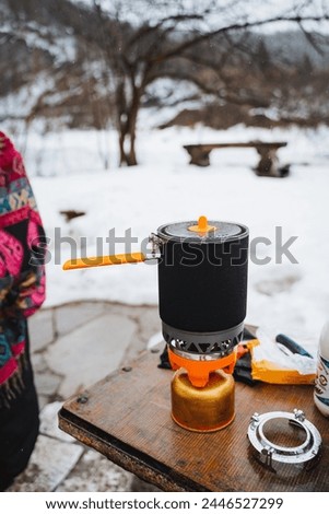 burner pot, camping kitchen, camping in the forest, hiking, cooking on a gas burner. High quality photo