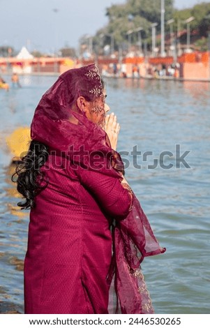 young devotee praying for holy god after bathing in holy river water at morning from flat angle Royalty-Free Stock Photo #2446530265