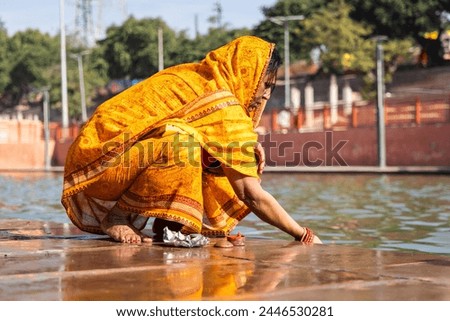 devotee praying for holy god after bathing in holy river water at morning from flat angle Royalty-Free Stock Photo #2446530281