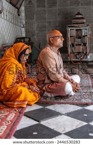 devotee couple praying for holy god at temple at morning from flat angle Royalty-Free Stock Photo #2446530283
