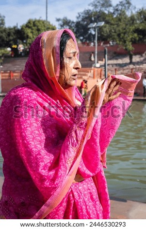 devotee praying for holy god after bathing in holy river water at morning from flat angle Royalty-Free Stock Photo #2446530293