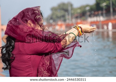 young devotee praying for holy god after bathing in holy river water at morning from flat angle Royalty-Free Stock Photo #2446530311
