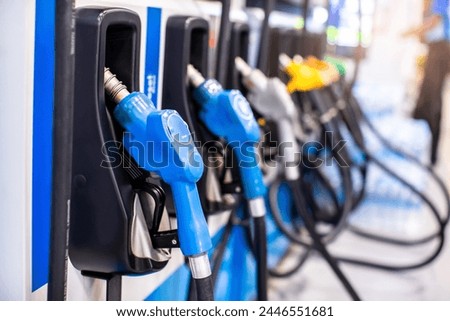 Selective focus to gas pump nozzles in a service station, Close up fuel nozzles at gas station, Panel and Dashboard of fuel nozzles of E85 E20 and Gasohol 91. The concept of fuel energy. Royalty-Free Stock Photo #2446551681