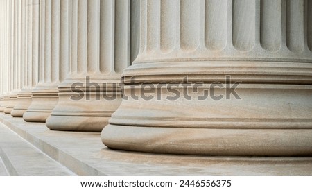 Architectural detail of some neoclassical columns symbolizing justice and the law of the land. Royalty-Free Stock Photo #2446556375