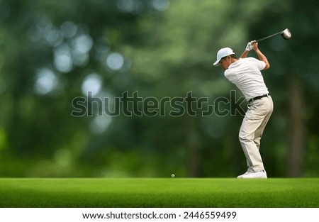 Front view of Golfer driver back swing before hitting golf ball down the fairway.