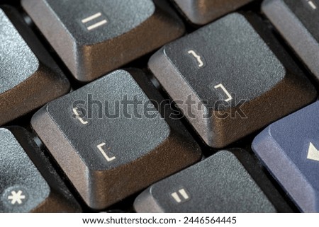 Curly brackets and square brackets, bracket symbol keys on a black computer keyboard, object macro, extreme closeup. Computer programming languages generic symbol, data structures list dict concept