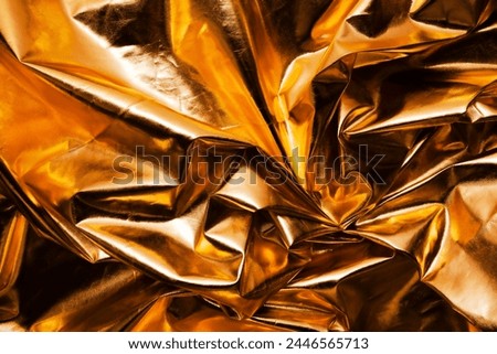 crumpled gold metallic reflector background texture 