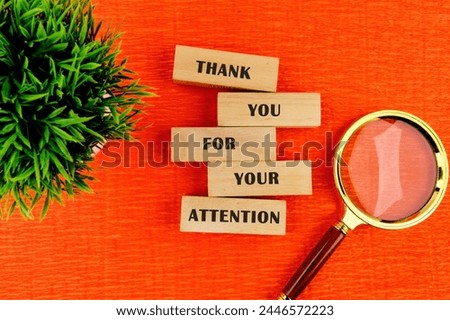 Thank you for your attention concept. Text written on wooden blocks. Bright orange background. Business concept. There is a calculator and a plant nearby
