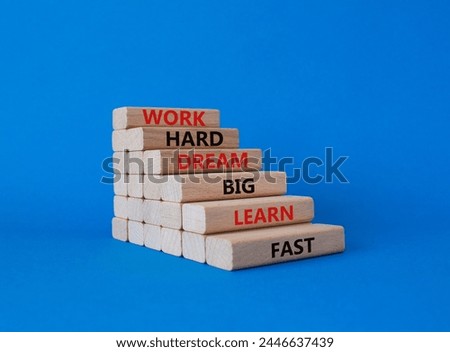 Work hard Dream big Learn fast symbol. Wooden blocks with words Work hard Dream big Learn fast. Beautiful blue background. Business and Work hard Dream big Learn fast. Copy space.