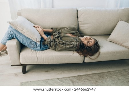 Restless Woman on Couch: Sadness, Stress, and Despair in Home-Depressed Mood Royalty-Free Stock Photo #2446662947